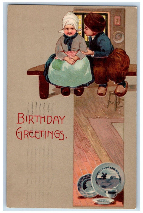 1908 Birthday Greetings Dutch Boy And Girl Sitting In A Table Embossed Postcard