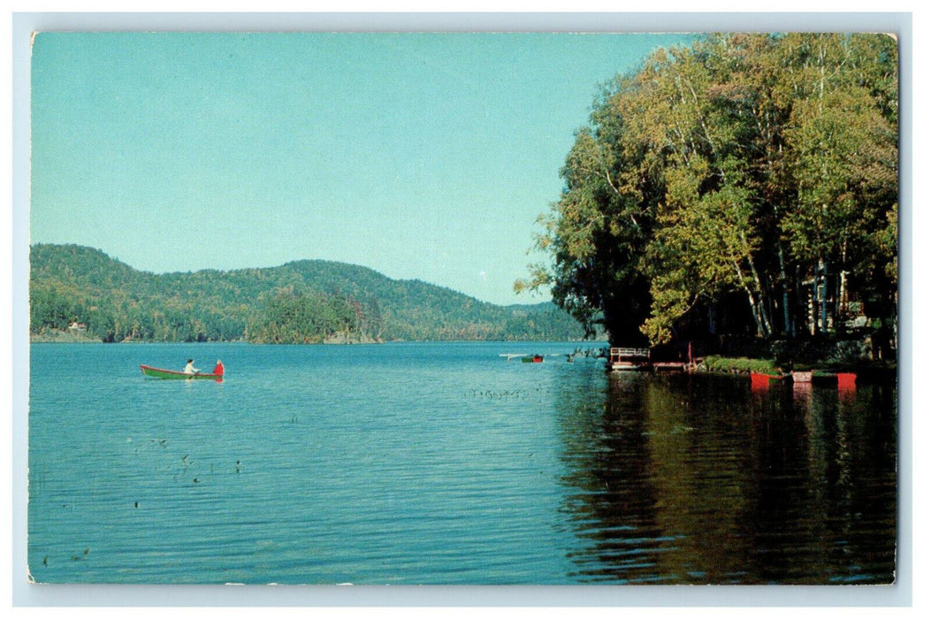 c1960s Two Men on Boat, Greetings From Chet's Camps on Big Lake ME Postcard