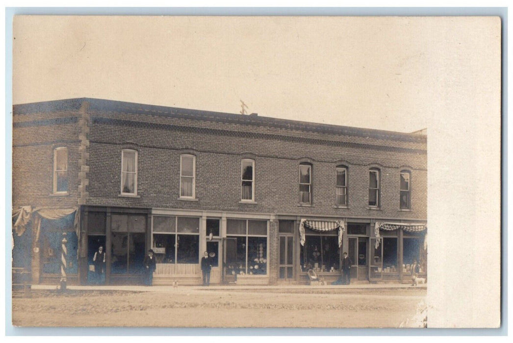 c1905 Storefronts Barber Pole Shop Dogs Optician Dirt Road RPPC Photo Postcard