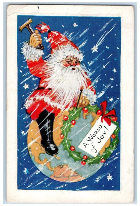 c1910's Christmas Santa Claus Riding Earth Ax Wreathe Holly Berries Postcard