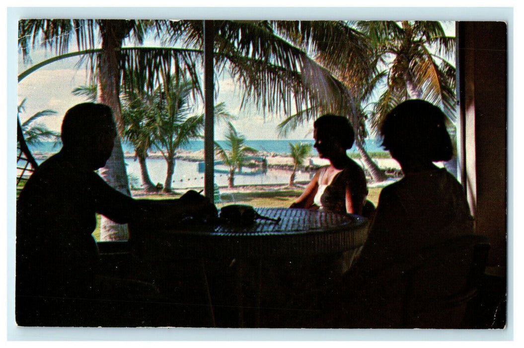 1967 Three Person Talking Inside a Cabin in Snug Harbor Resort Postcard