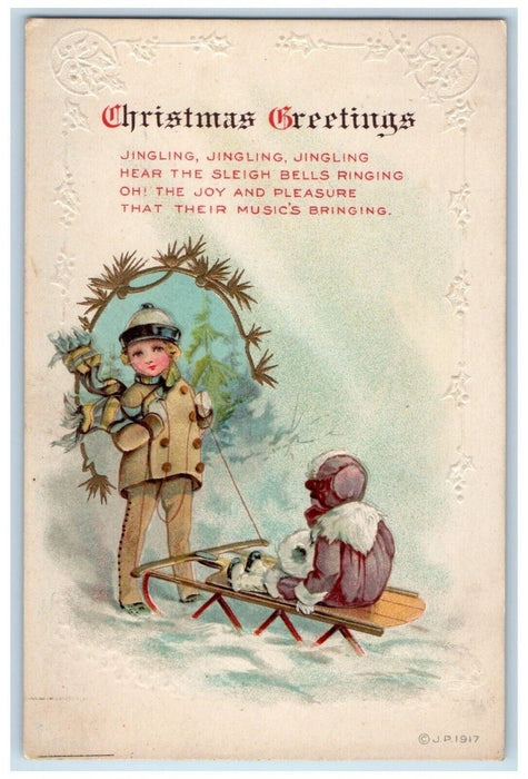 c1910's Christmas Greetings Boy Girl Sledding Winter Snow Embossed Postcard
