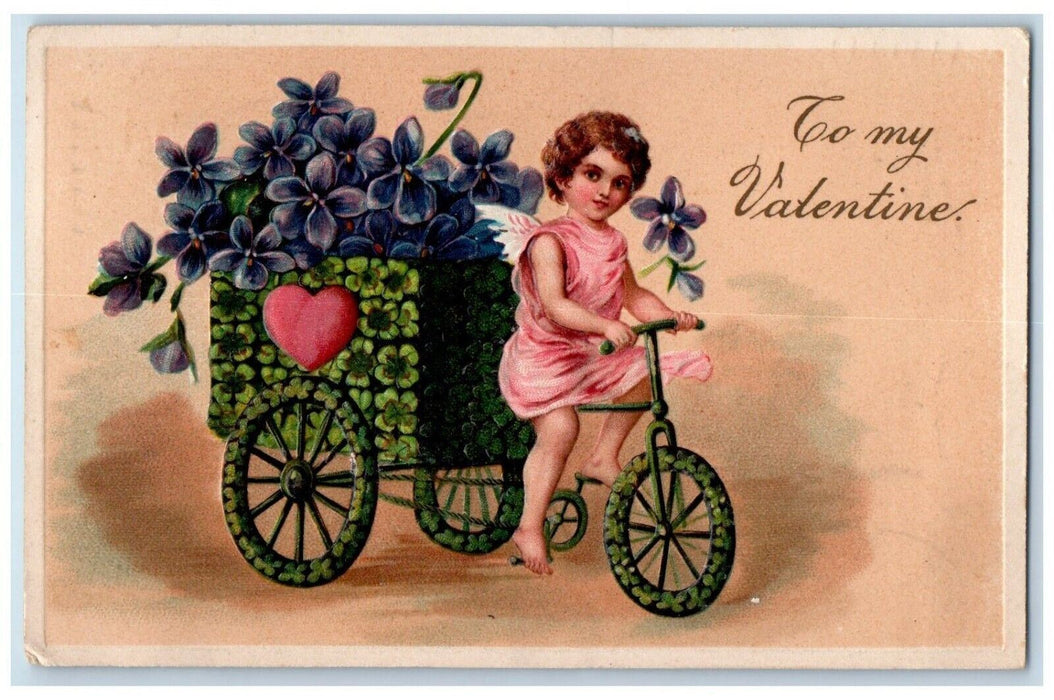 1909 Valentine Angel Driving Bicycle Shamrock Pansies Flowers Embossed Postcard