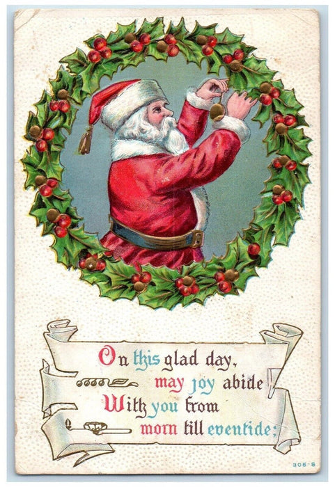 1909 Christmas Santa Claus Designing Wreath Holly Berries Embossed Postcard