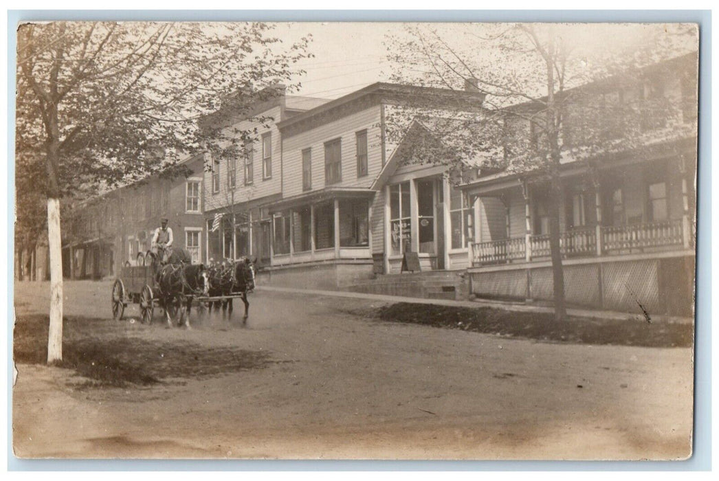 c1910 Horse Wagon Flag Candies Restaurant Casks Dirt Road RPPC Photo Postcard