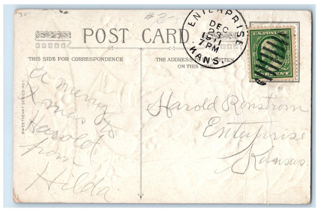 1911 Christmas Ringing Bell Santa Claus Pipe Holly Berries Embossed Postcard