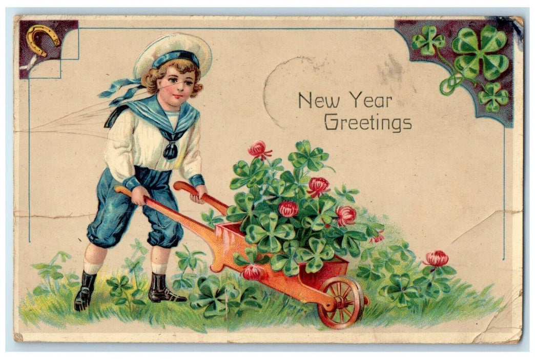 1915 New Year Greetings Boy Pushing Wagon With Shamrock Clover Gel Postcard