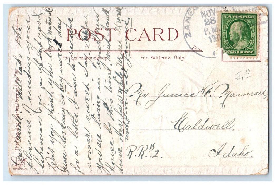 1911 Thanksgiving Greetings Man Ringing Bells Embossed Caldwell ID Postcard