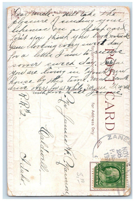 1911 Thanksgiving Greetings Man Ringing Bells Embossed Caldwell ID Postcard