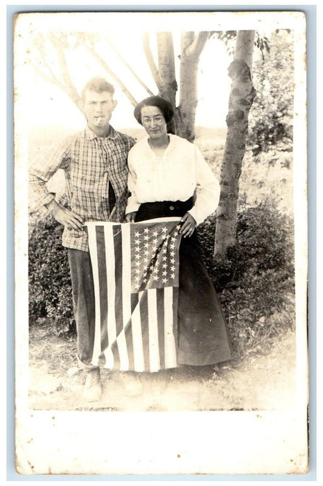 c1910's 4th July Patriotic Couple Holding American Flag RPPC Photo Postcard