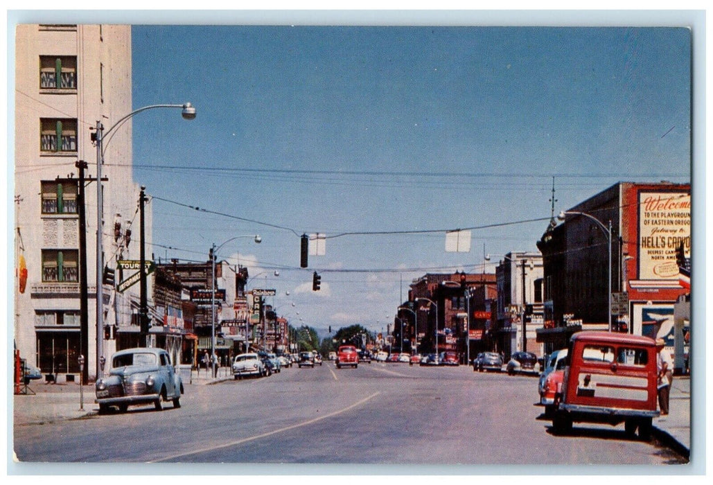c1960 Busy Day Classic Cars Buildings Main Street Baker Oregon Unposted Postcard