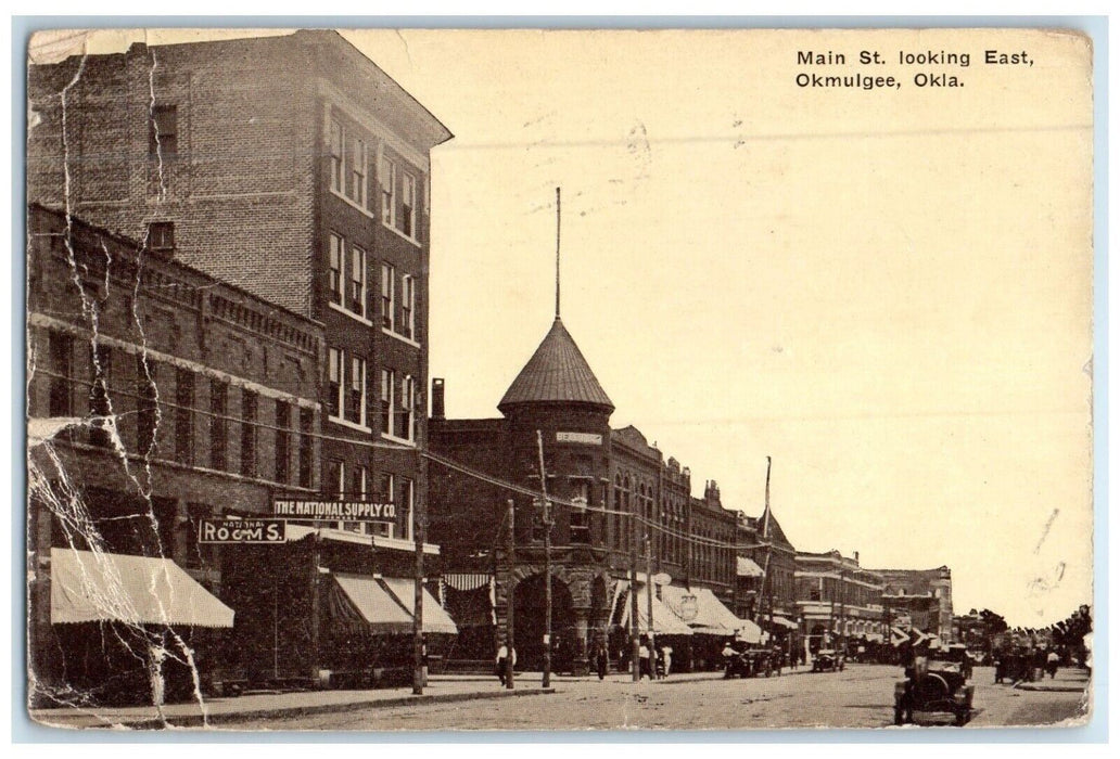1917 Busy Day Buildings Road Main St Looking East Okmulgee Oklahoma OK Postcard